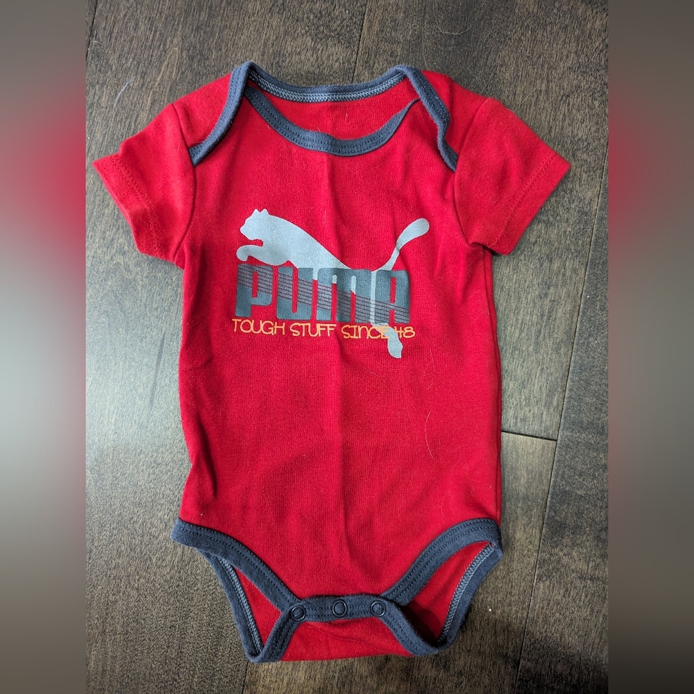 Puma gender neutral baby onesie in red.